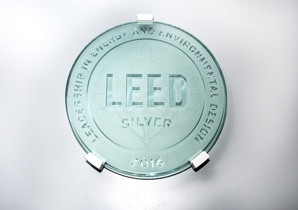 a circle glass plaque of sustainable living guide